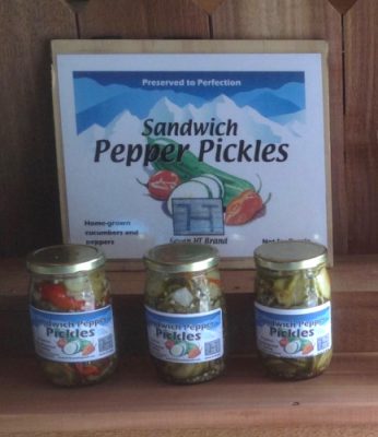 Jars of Seven HT sandwich pepper pickles under their sign