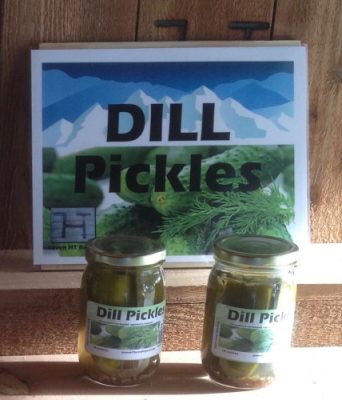 Jars of Seven HT dill pickles under their sign